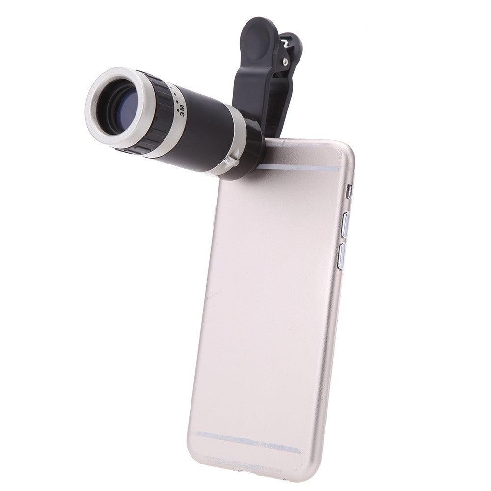 Phone with a clip-on telescope attachment on a white background