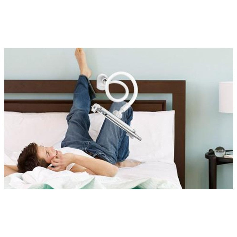 Person using a white ring light on a bed with a neutral background