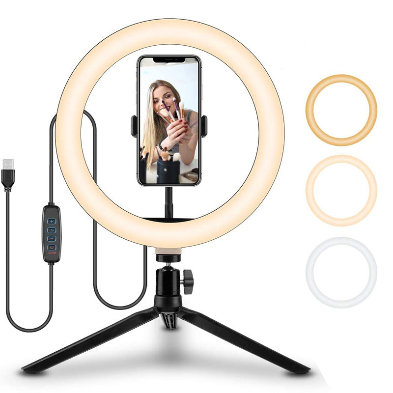 Ring light with smartphone holder on a tripod, featuring a phone screen displaying a person using the product.