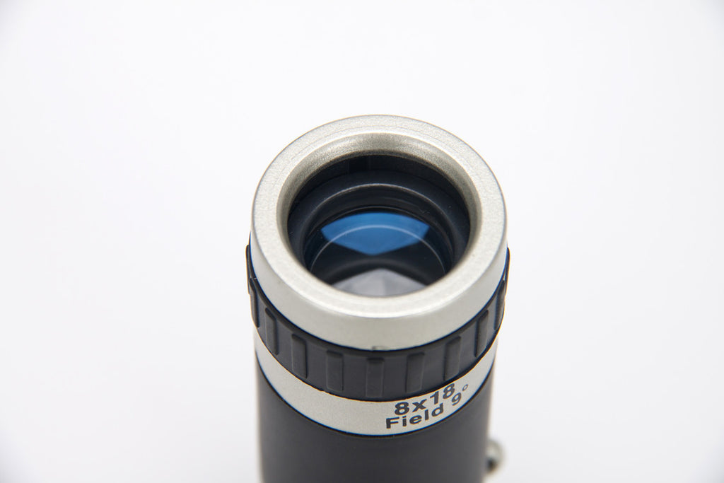 Telescope lens with '8x18 Field' marking on a white background