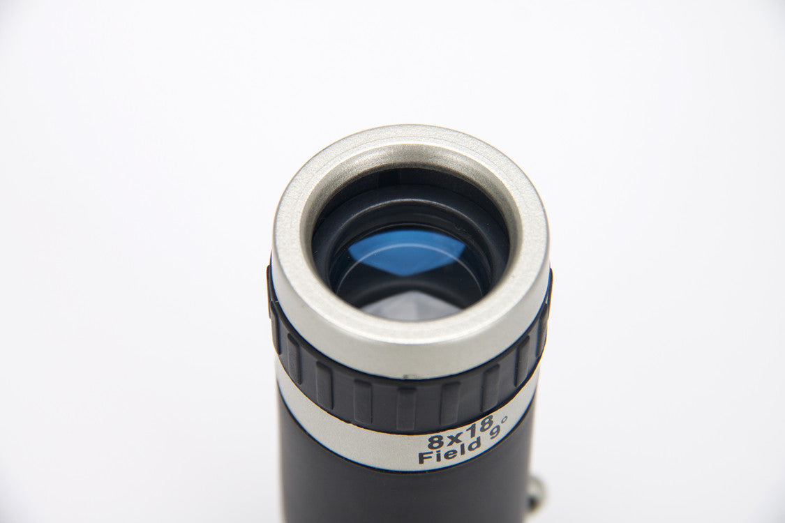 Telescope lens with '8x18 Field' marking on a white background