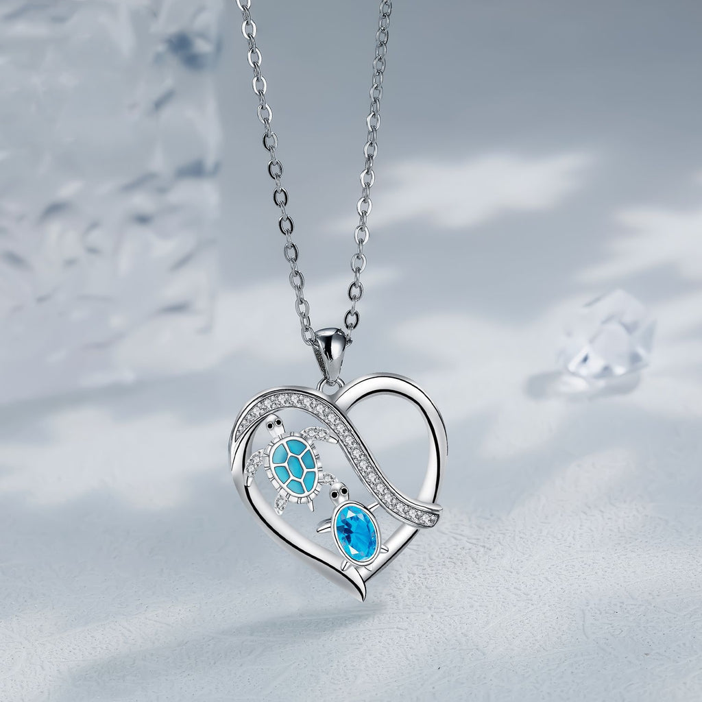 Heart-shaped silver necklace with blue gemstones on a soft gray background